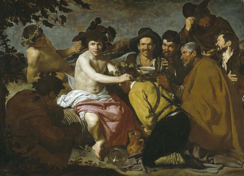 Diego Velรกzquez's Baroque painting The Triumph of Bacchus (Los Borrachos), showing the god of wine crowning a kneeling man surrounded by a group of smiling, realistic peasants.