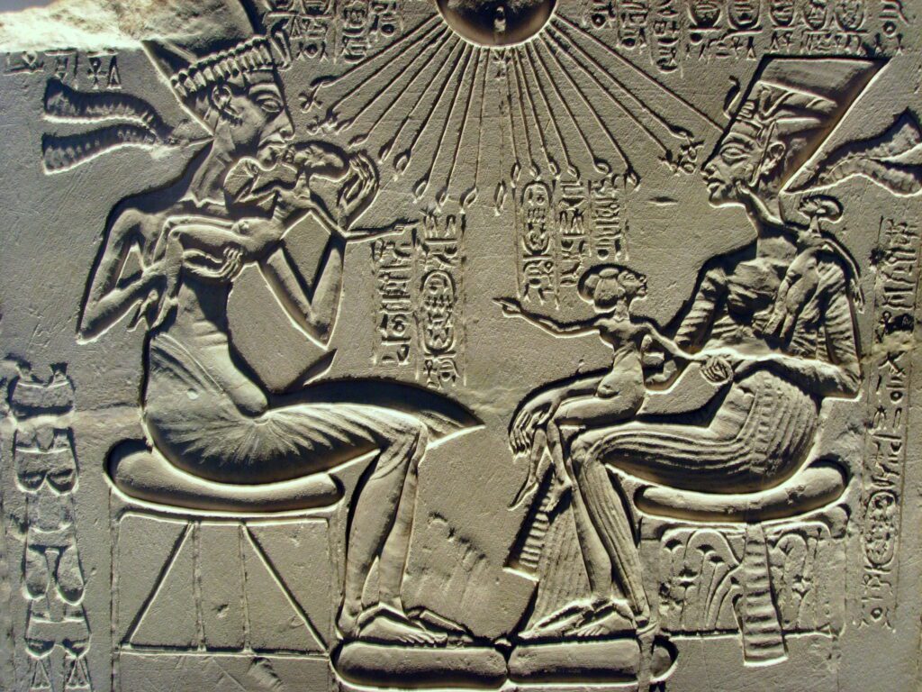 Pharaoh Akhenaten, Queen Nefertiti and their children, worshipping the sun god Aten.