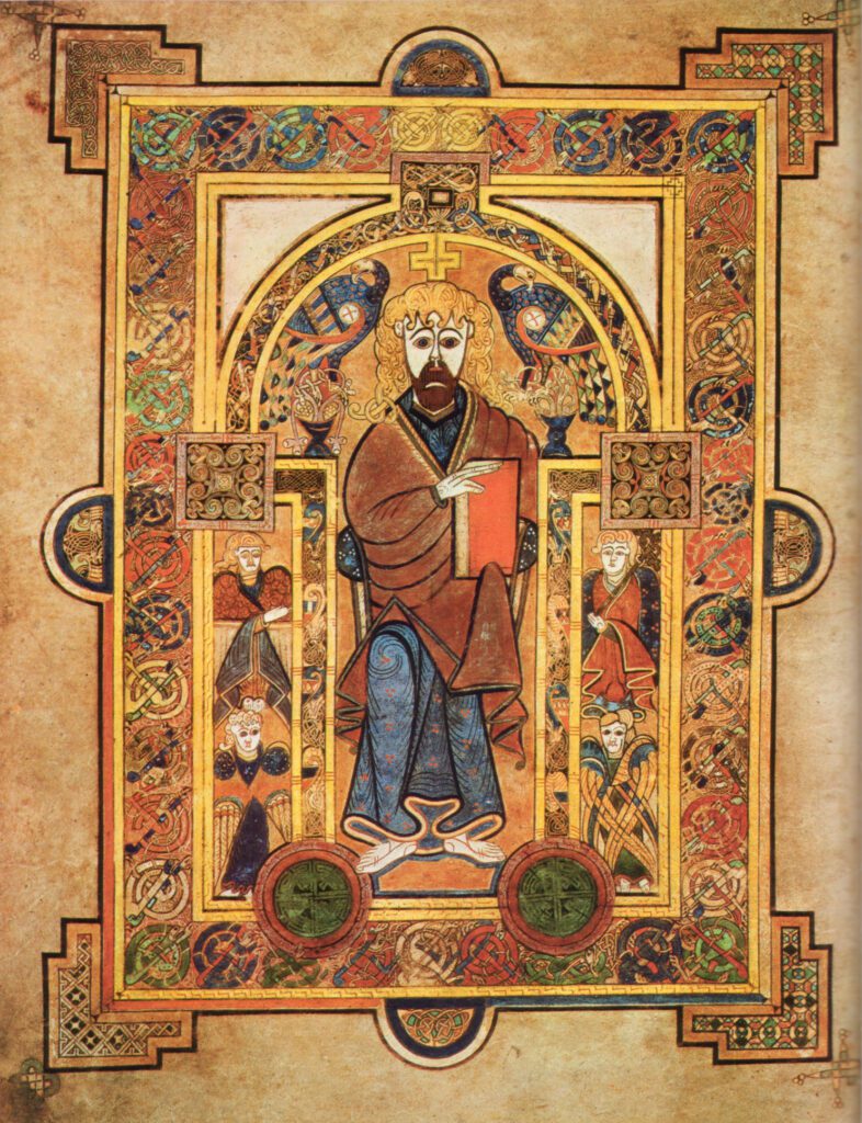 Insular illuminated manuscript folio from the Book of Kells showing a stylized Christ enthroned holding a book, flanked by peacocks and angels.